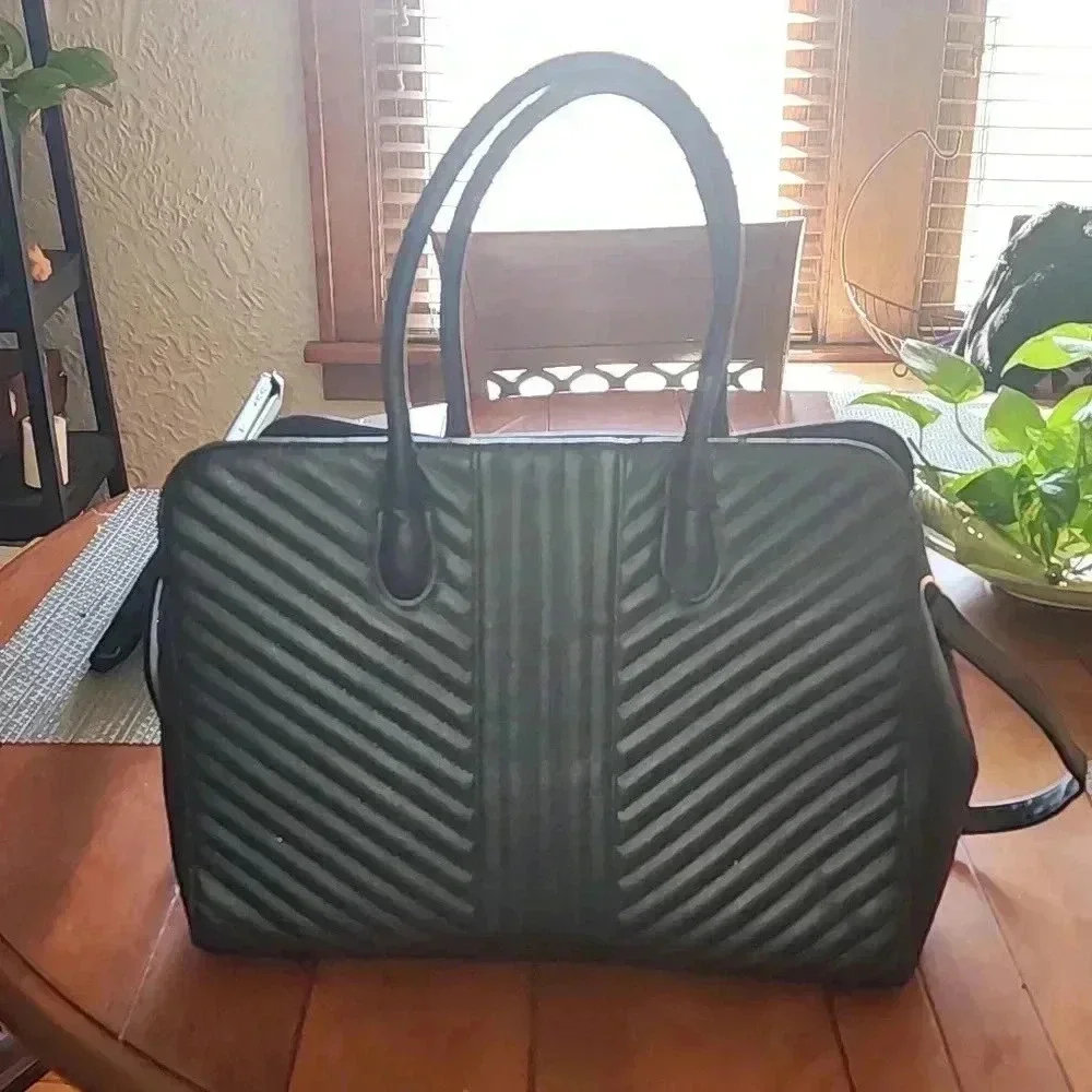 A new day tm.large bag great for laptop 💻 like new use only at few times.